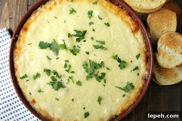 Chicken Alfredo Dip in baking dish and parsley