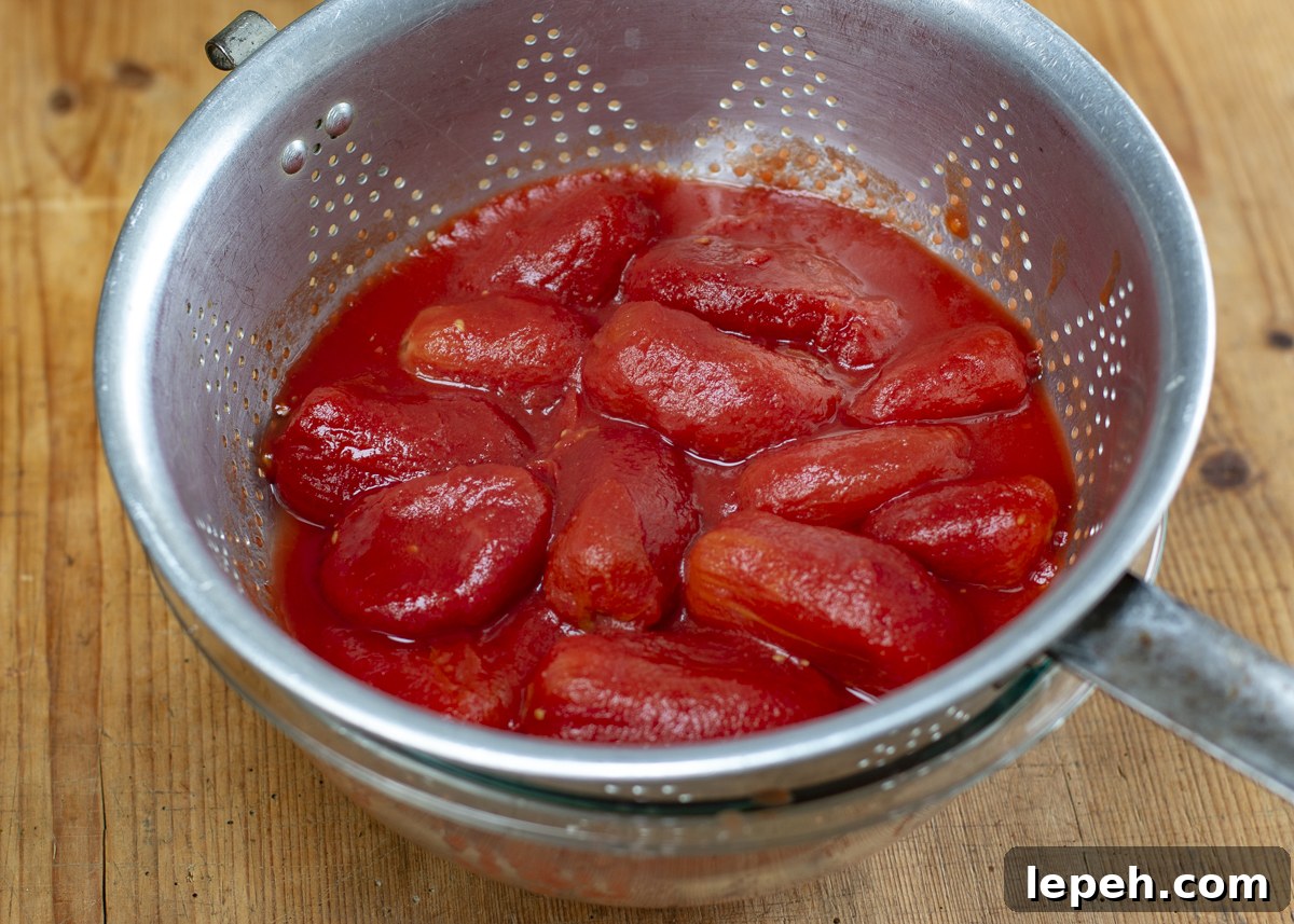 Peeled San Marzano plum tomatoes draining their juices 
