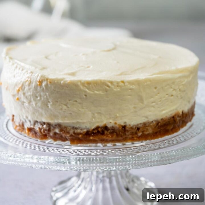 A whole Philadelphia No Bake Cheesecake on a cake serving tray.
