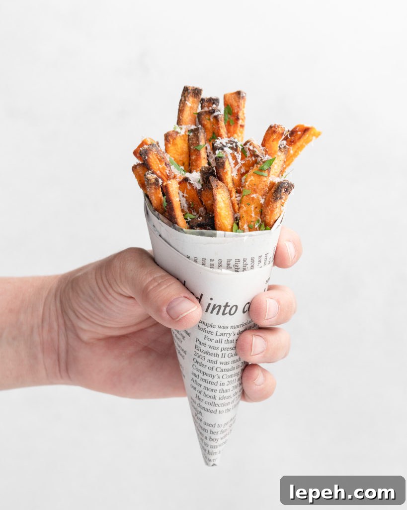 crispy oven baked yam fries are topped with finely shredded parmesan cheese and served with a flavorful homemade truffle lemon aioli