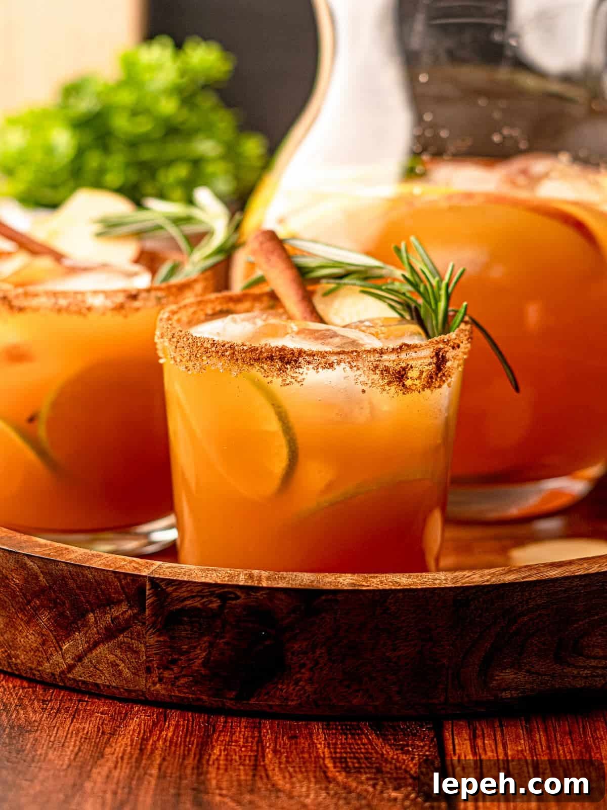Cocktails and a pitcher on a serving tray.