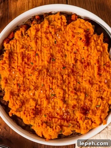Casserole dish full of beef and sweet potato pie.