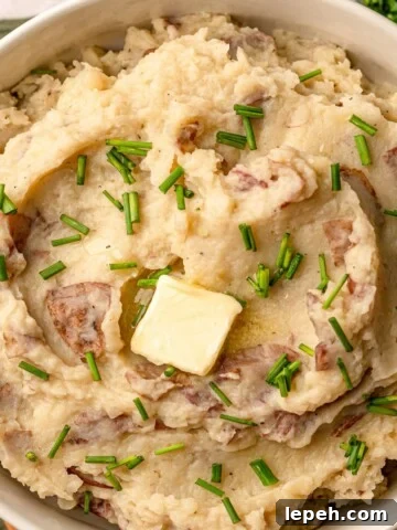 Mashed potatoes with melted butter on top.