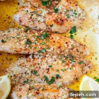 Square image of baked lemon butter tilapia.