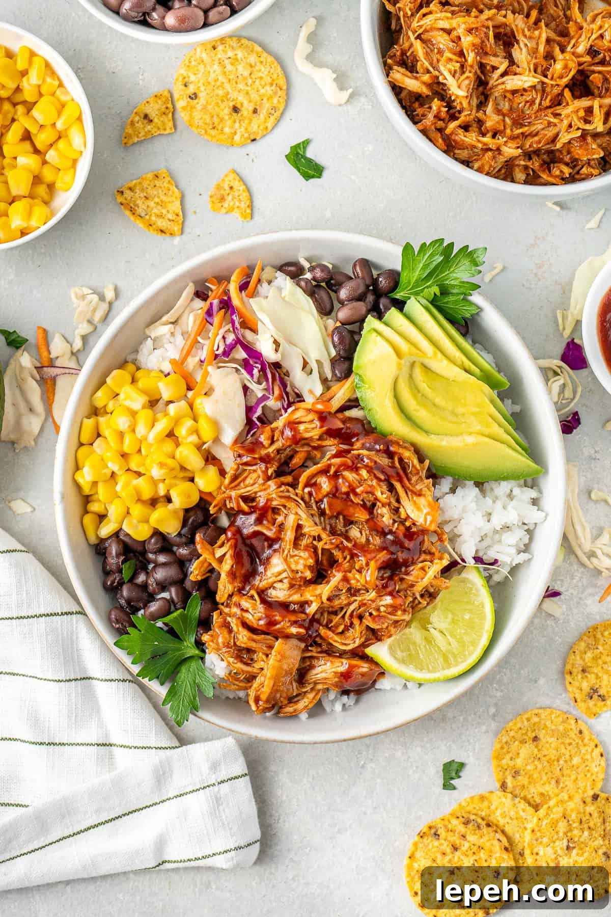 BBQ chicken bowls with veggies and corn chips.