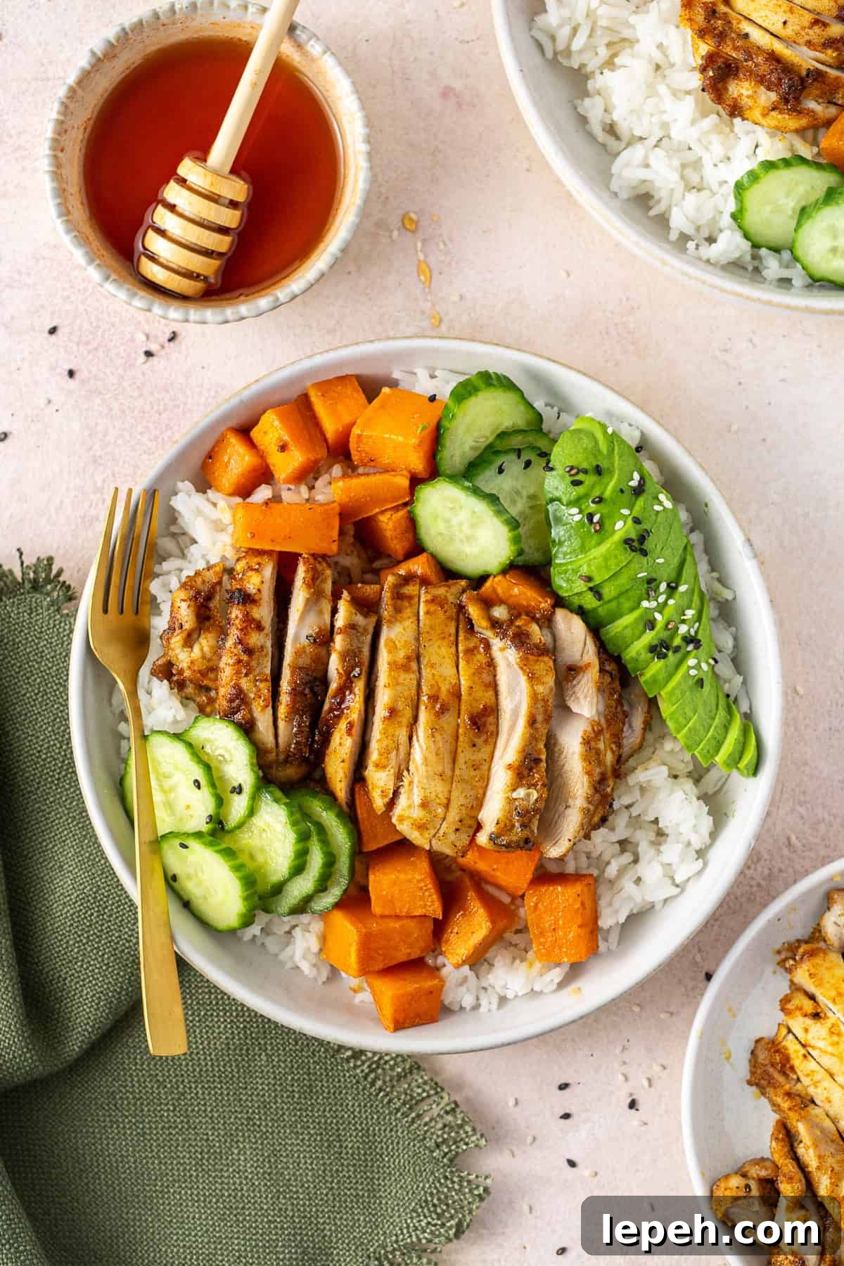 Sliced hot honey chicken in a bowl with rice.