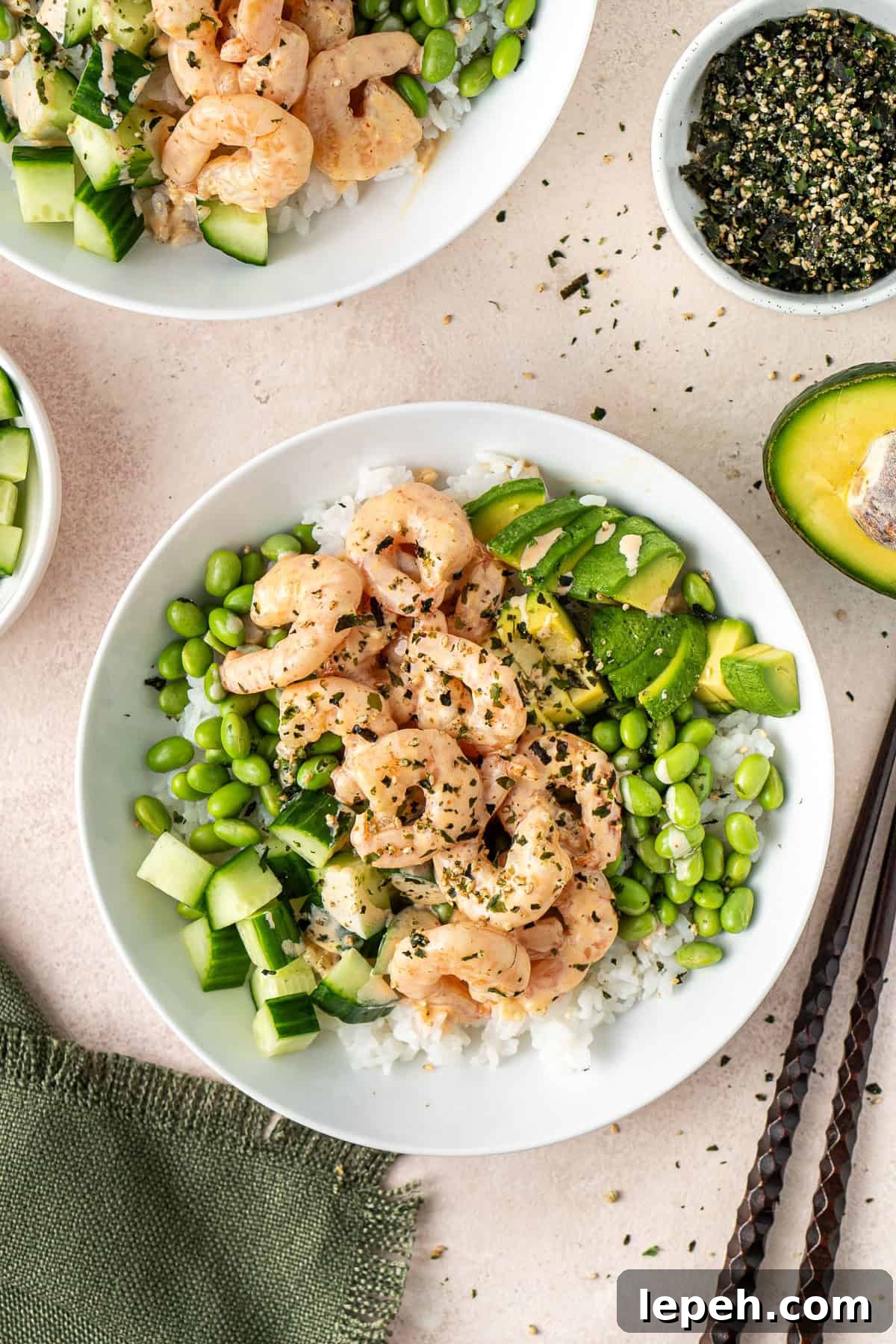 Spicy prawns in a bowl with avocado cucumber and edamame. 