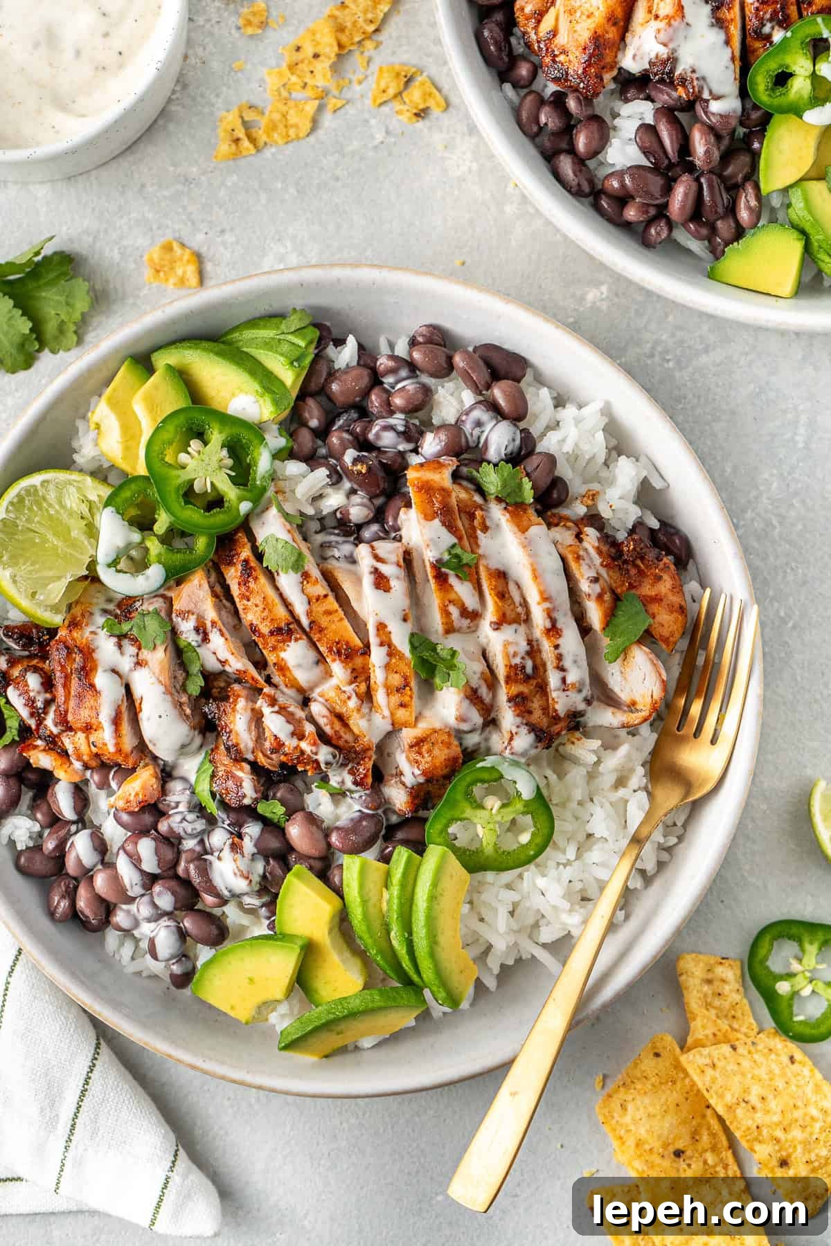 Chipotle chicken bowls with jalapenos and corn chips. 