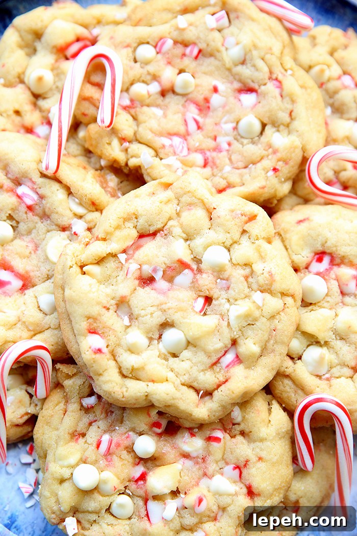 White Chocolate Peppermint Cookies with small candy canes on a large plate.