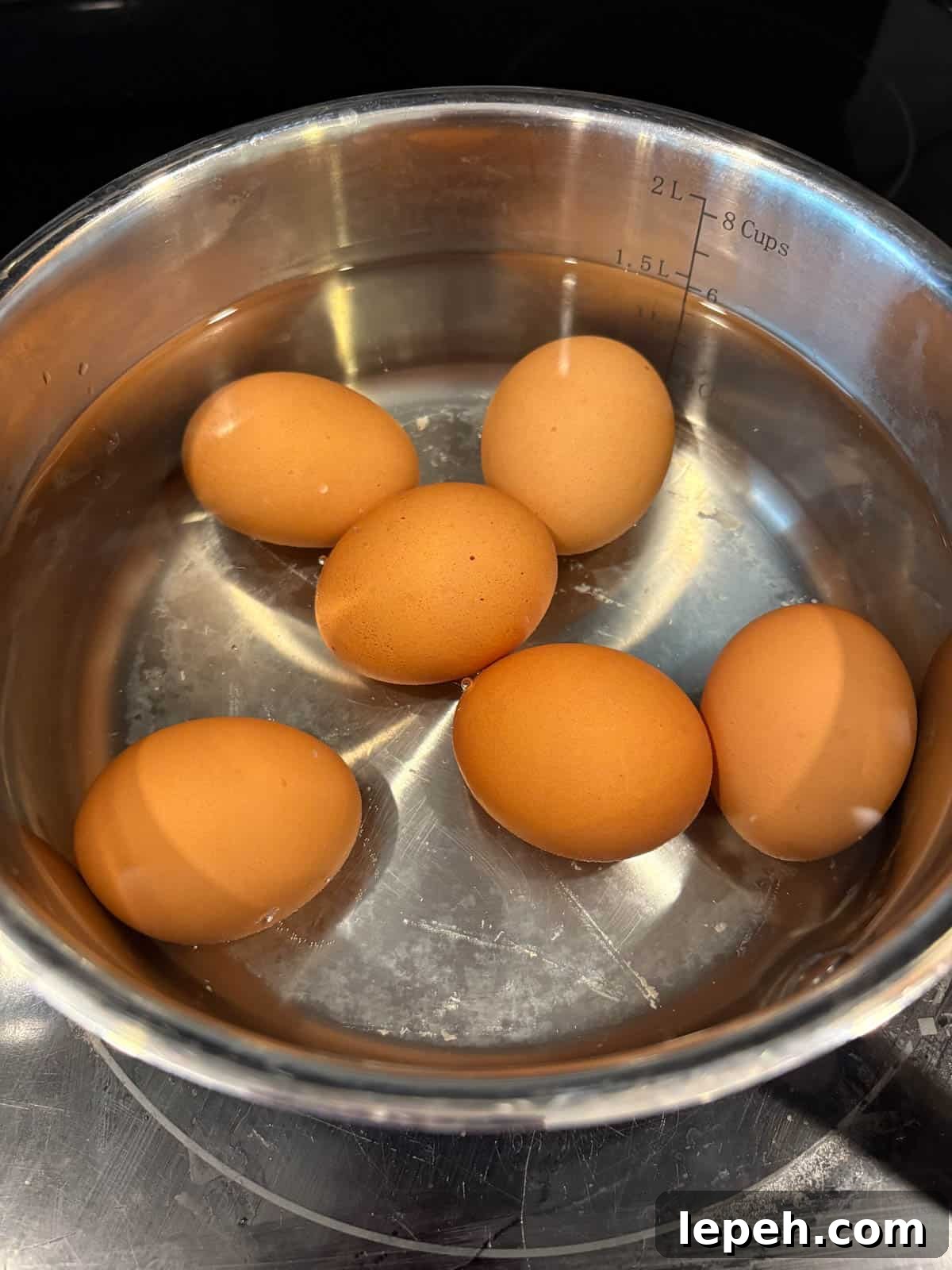 Eggs boiling in a pan.