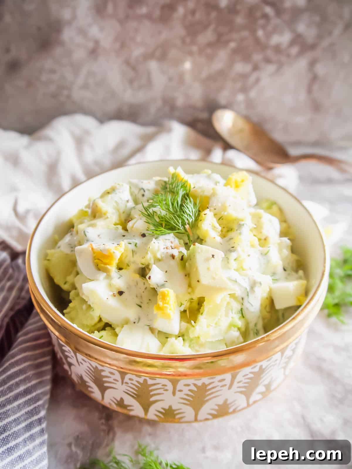 Homemade egg potato salad with avocado in a bowl.