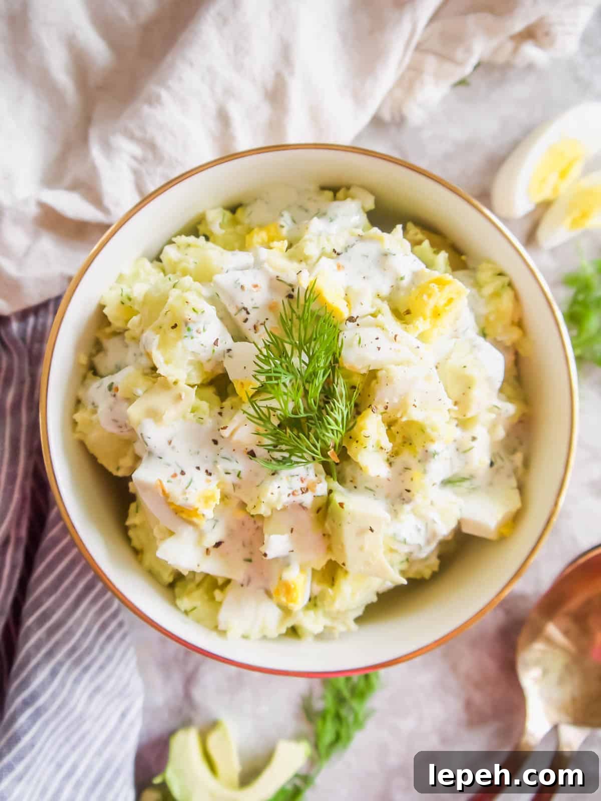 Dill Ranch Potato Salad with Avocado and Eggs in a bowl with fresh dill on top.