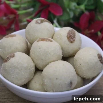Maharashtrian Rava Ladoo placed on a white bowl on a brown counter top.
