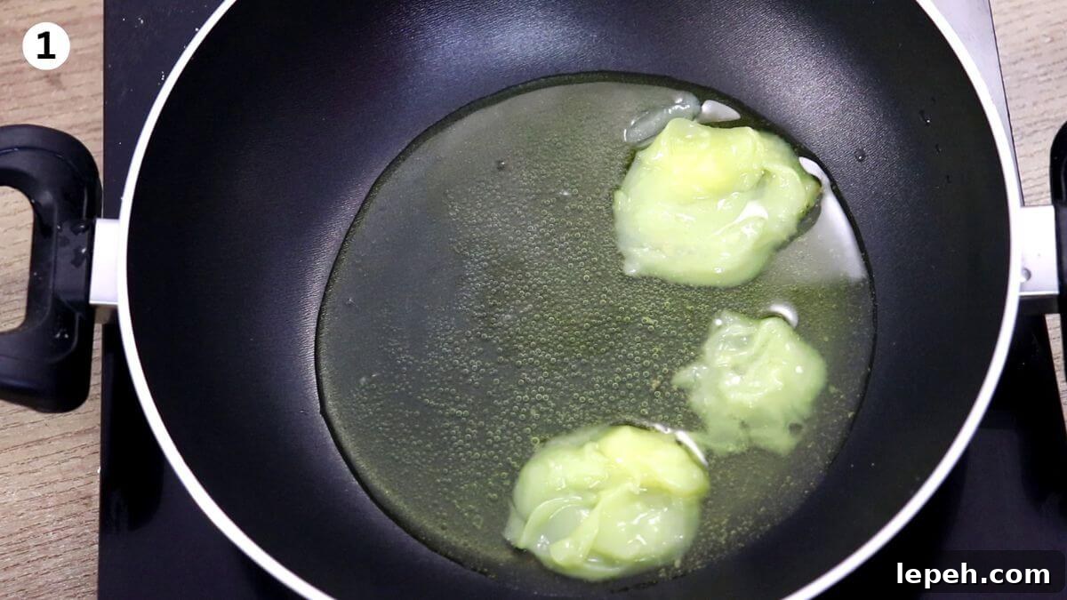 melting ghee in a pan to make danedar besan ladoo.