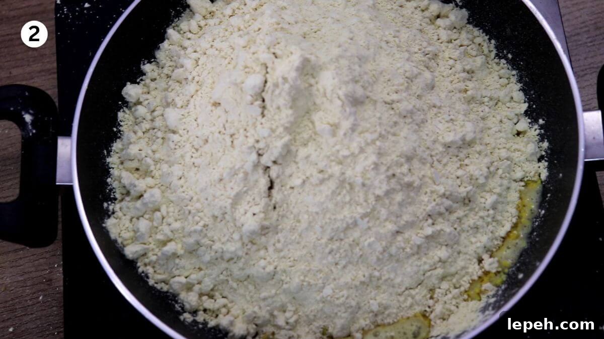 addition of besan to pan to make halwai style besan ladoo.
