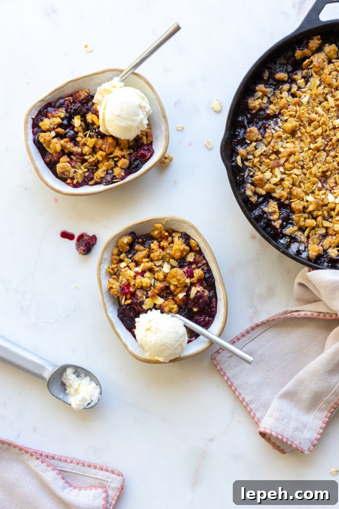 Mixed Berry Oat Almond Crisp served with vanilla ice cream