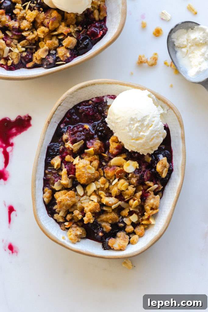 Mixed Berry Oat Almond Crisp with a scoop of vanilla ice cream