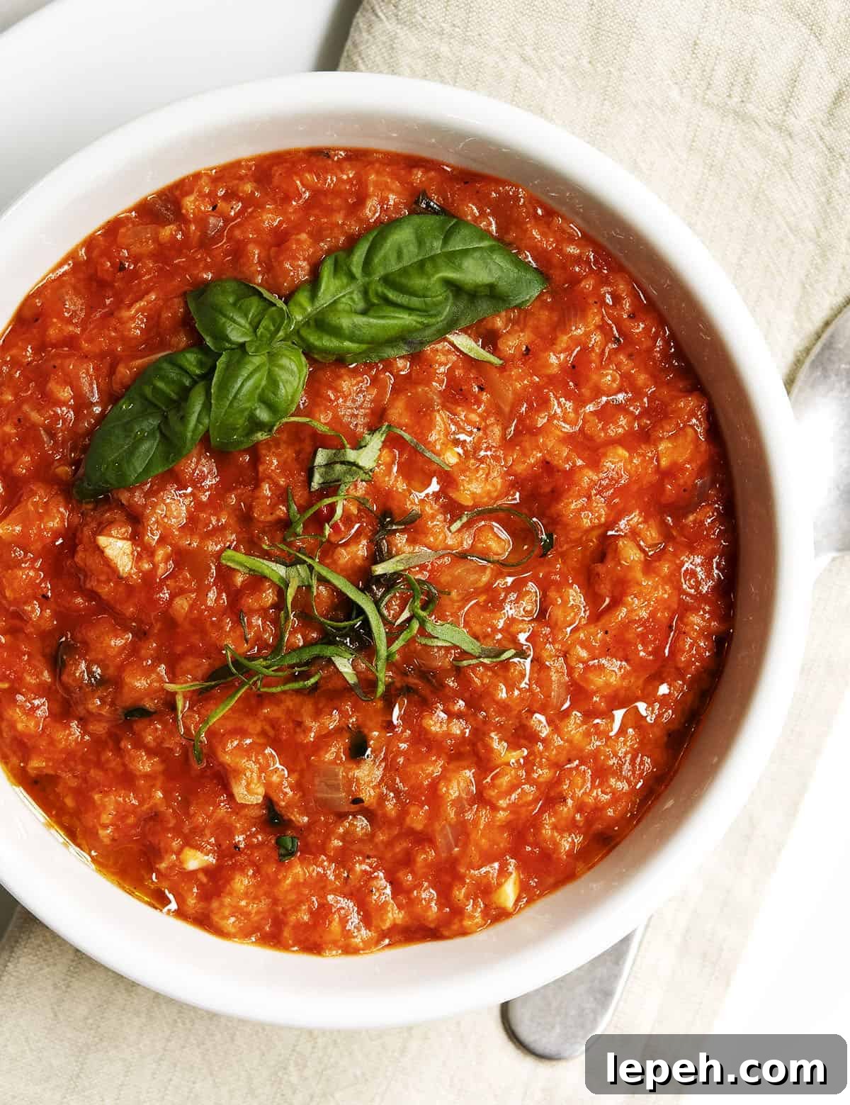 Pappa al Pomodoro served in a white bowl on a linen napkin photographed from above