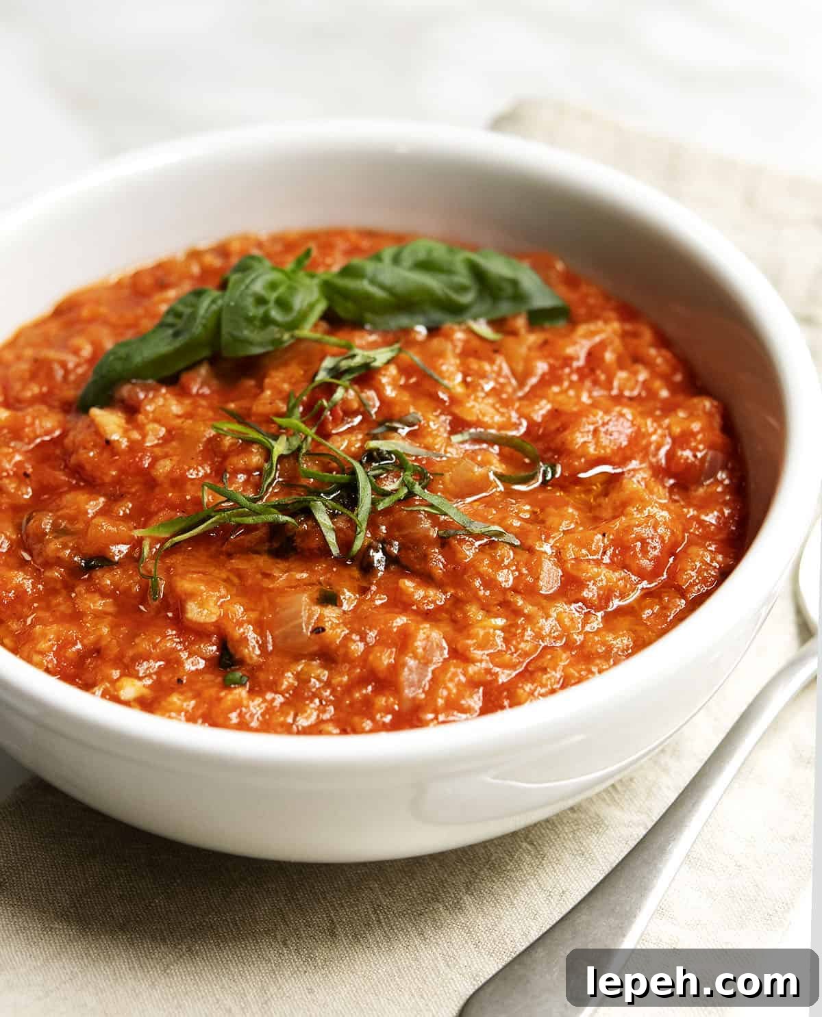Pappa al Pomodoro served in a white bowl on a linen napkin
