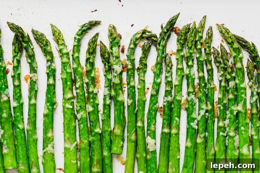 Overhead landscape style image of crispy oven roasted asparagus with lots of garlic. 