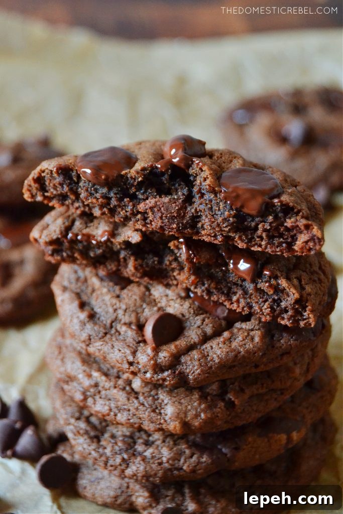 tall stack of chocolate chip cookies with one split open