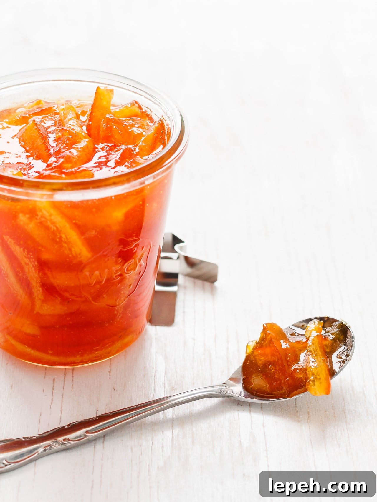 Homemade marmalade in a weck jar, served by the spoonful.