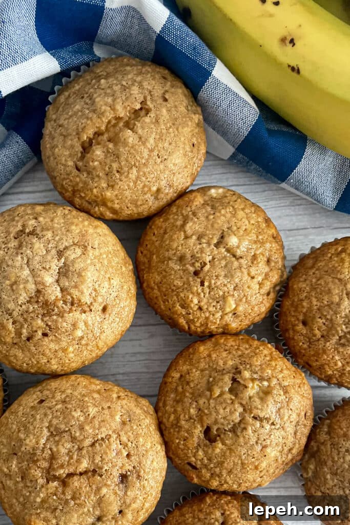 banana muffins on a serving tray with a banana in the top right corner