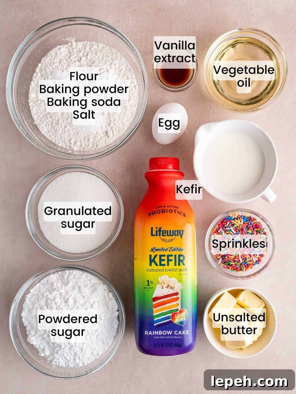 Ingredients needed to make a rainbow sprinkle cake with vanilla buttercream frosting.