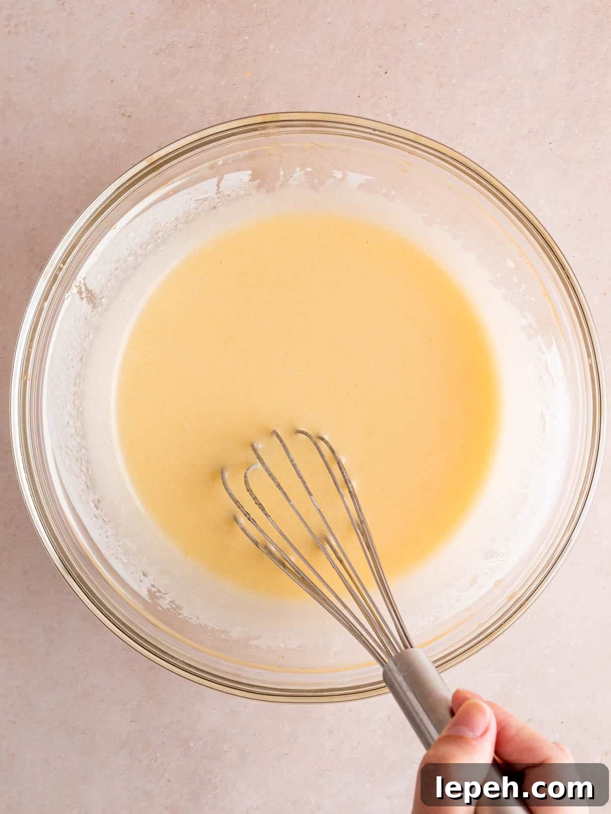Whisking sugar, vegetable oil, egg, vanilla extract, and kefir in a bowl.