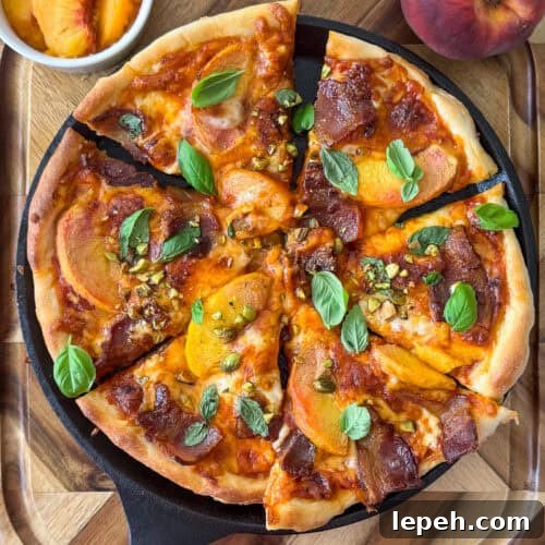 Slice of peach and bacon pizza on a plate