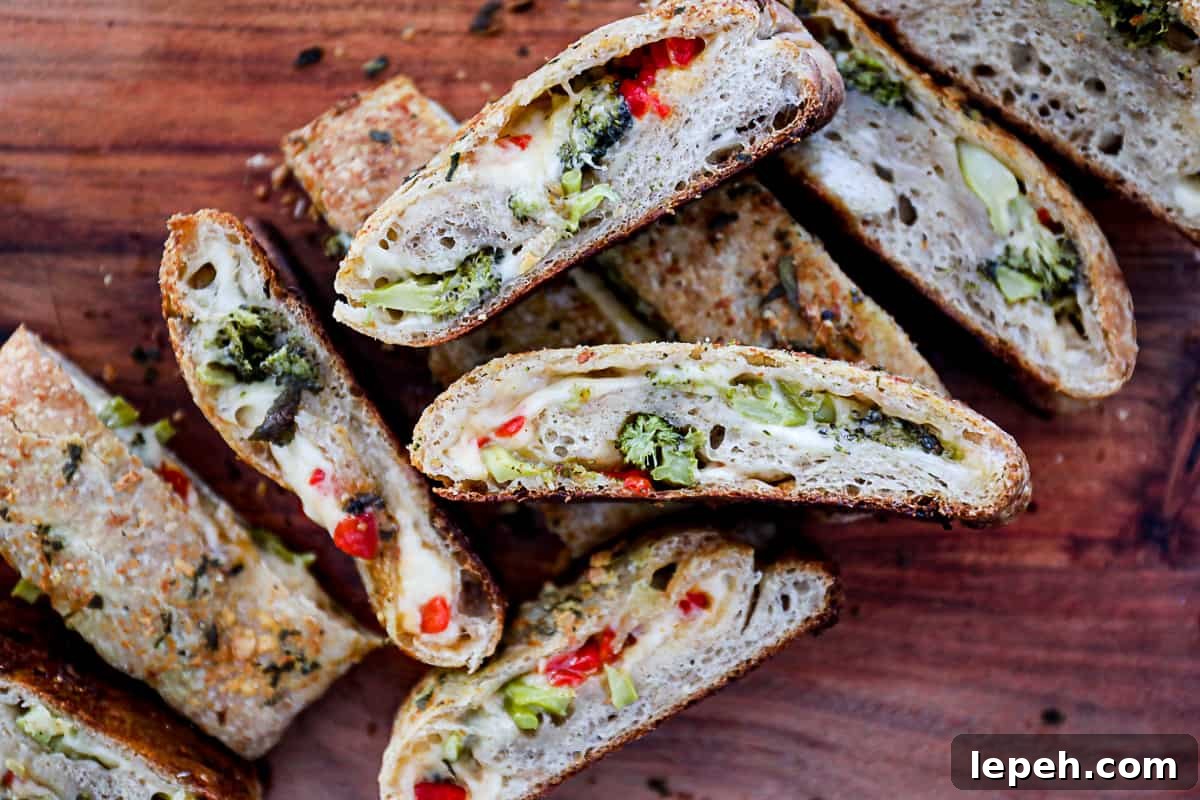Vegetable Stromboli with broccoli and cheese on a cutting board