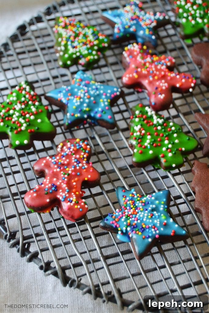 frosted chocolate sugar cookies on a black wire rack