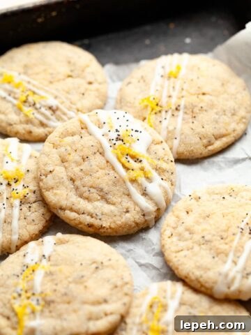 gluten free lemon poppy seed cookies topped with a lemon glaze, lemon sugar and poppy seeds