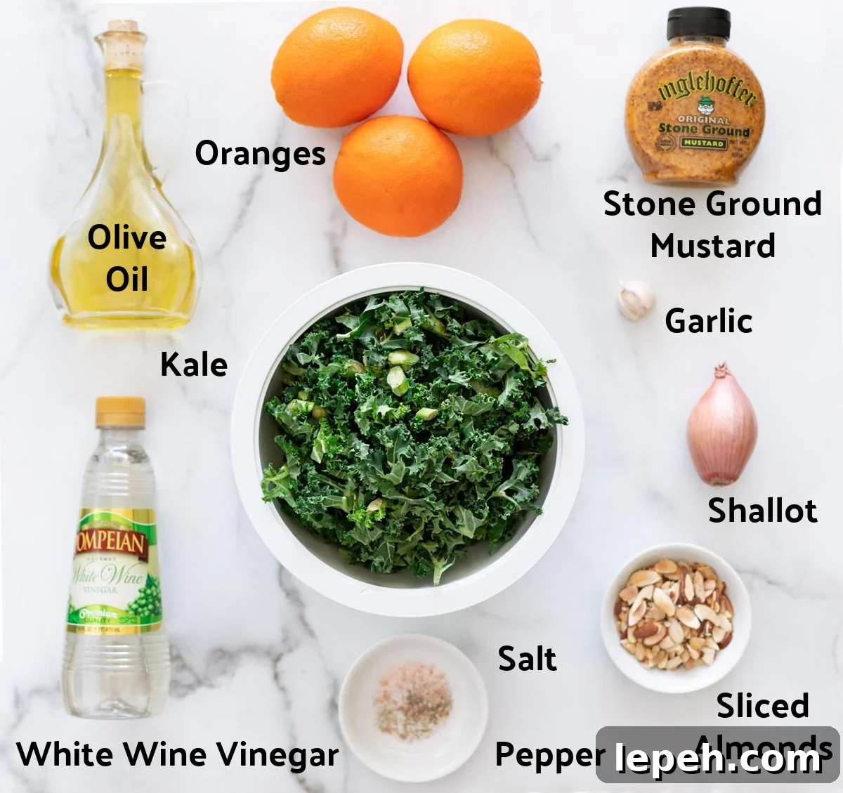 Ingredients to make a kale salad and vinaigrette dressing on a counter.