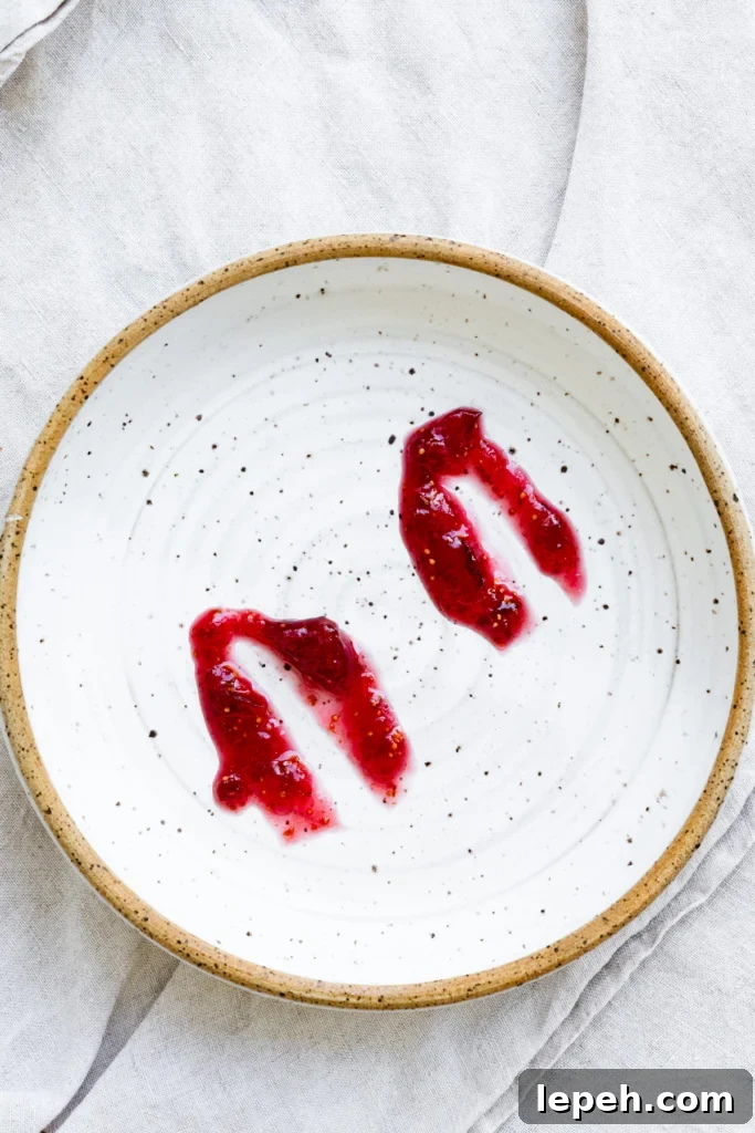 Fig jam spread onto a cold plate with a line through it to test for doneness.