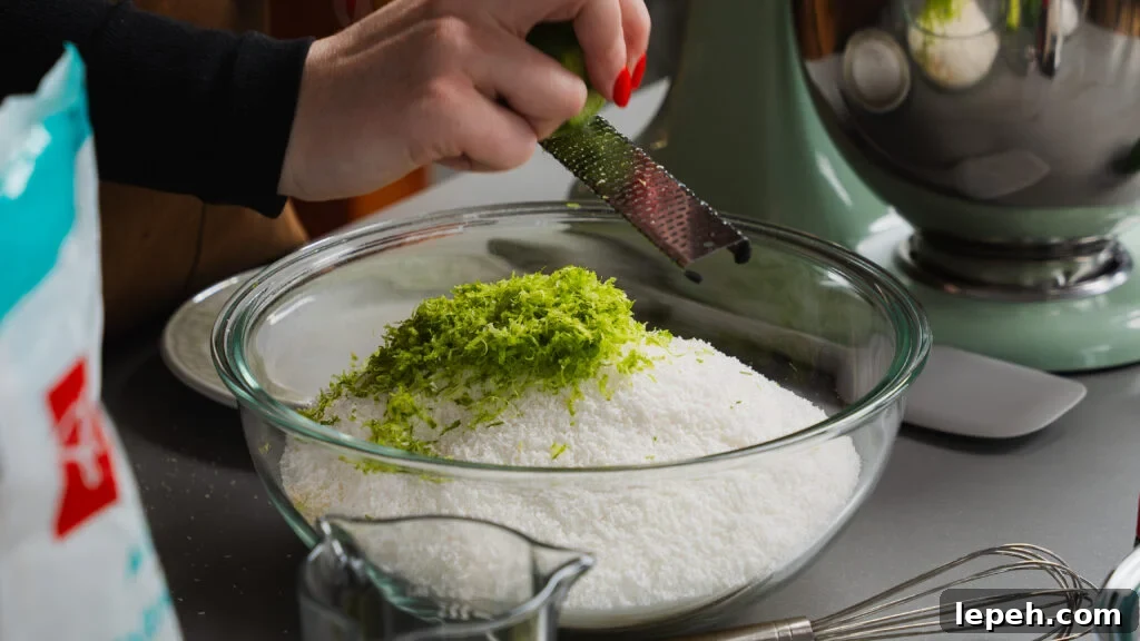 Adding lime zest to a bowl of amaretti cookie ingredients.