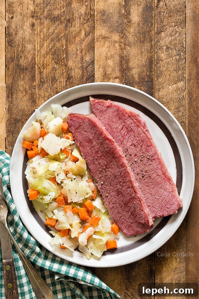 Corned Beef and Cabbage on brown plate with green napkin