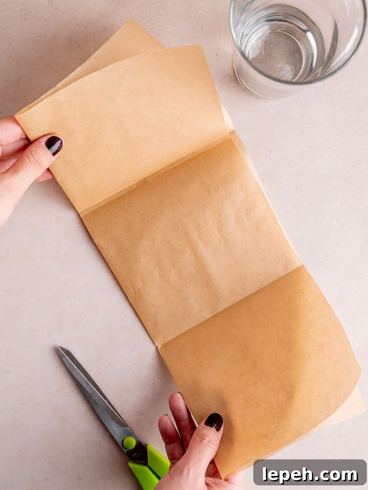 Folding parchment paper into thirds like a brochure.