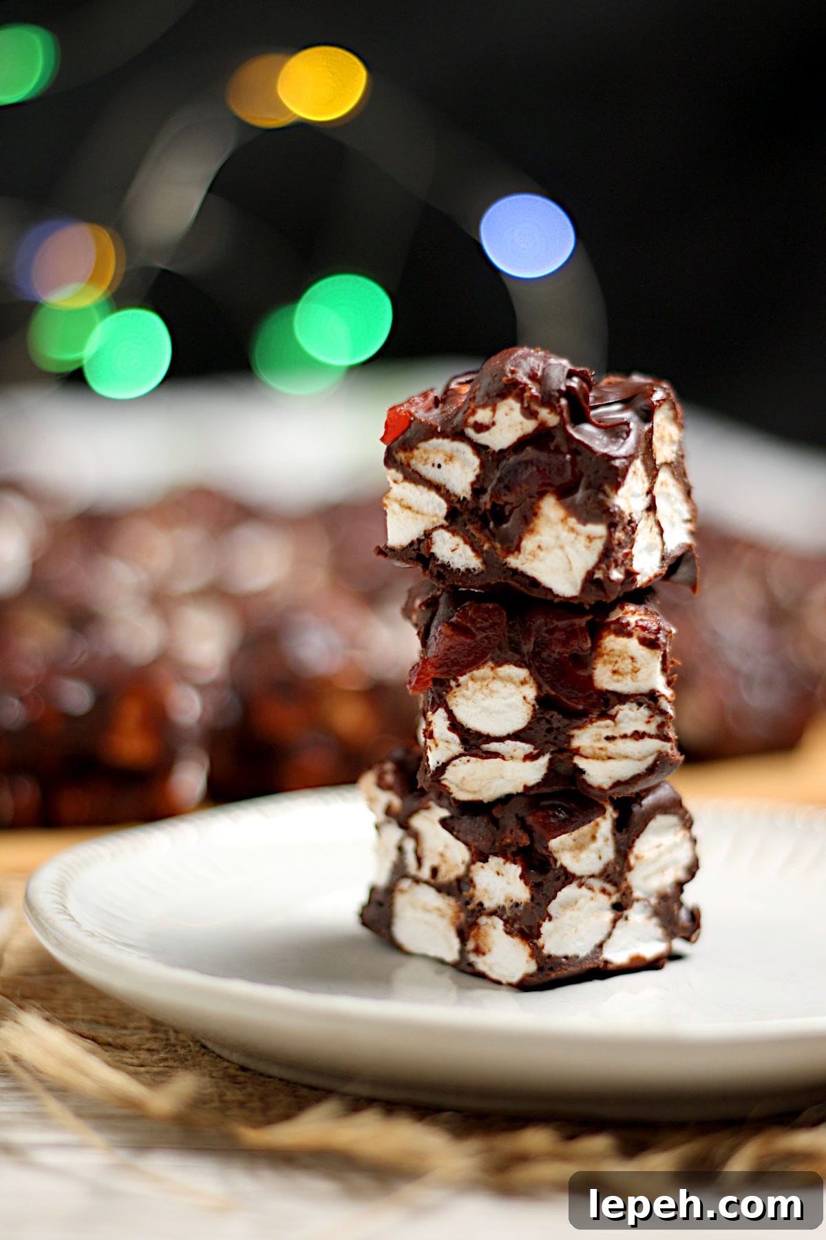 A stack of Chocolate Cherry Marshmallow Squares on a small white plate.