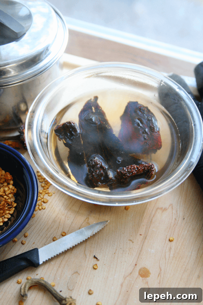 Dried peppers sitting in boiling water.