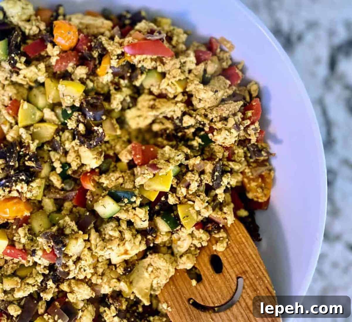 Mediterranean tofu scramble recipe in a bowl on the table.