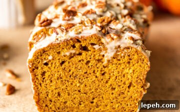 Slices of Maple Glazed Pumpkin Bread with chopped pecans on top