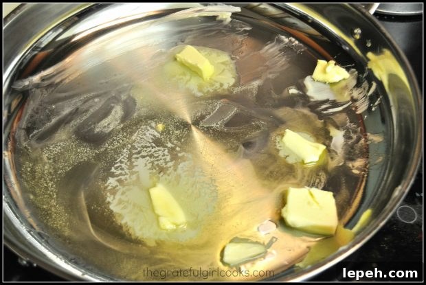 Olive oil and butter melting in skillet for coq au vin.