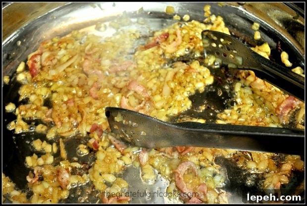 Chopped onions and bacon are cooked until fat is rendered.