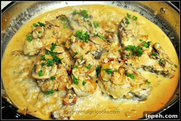Coq au vin is served, garnished with chopped parsley.