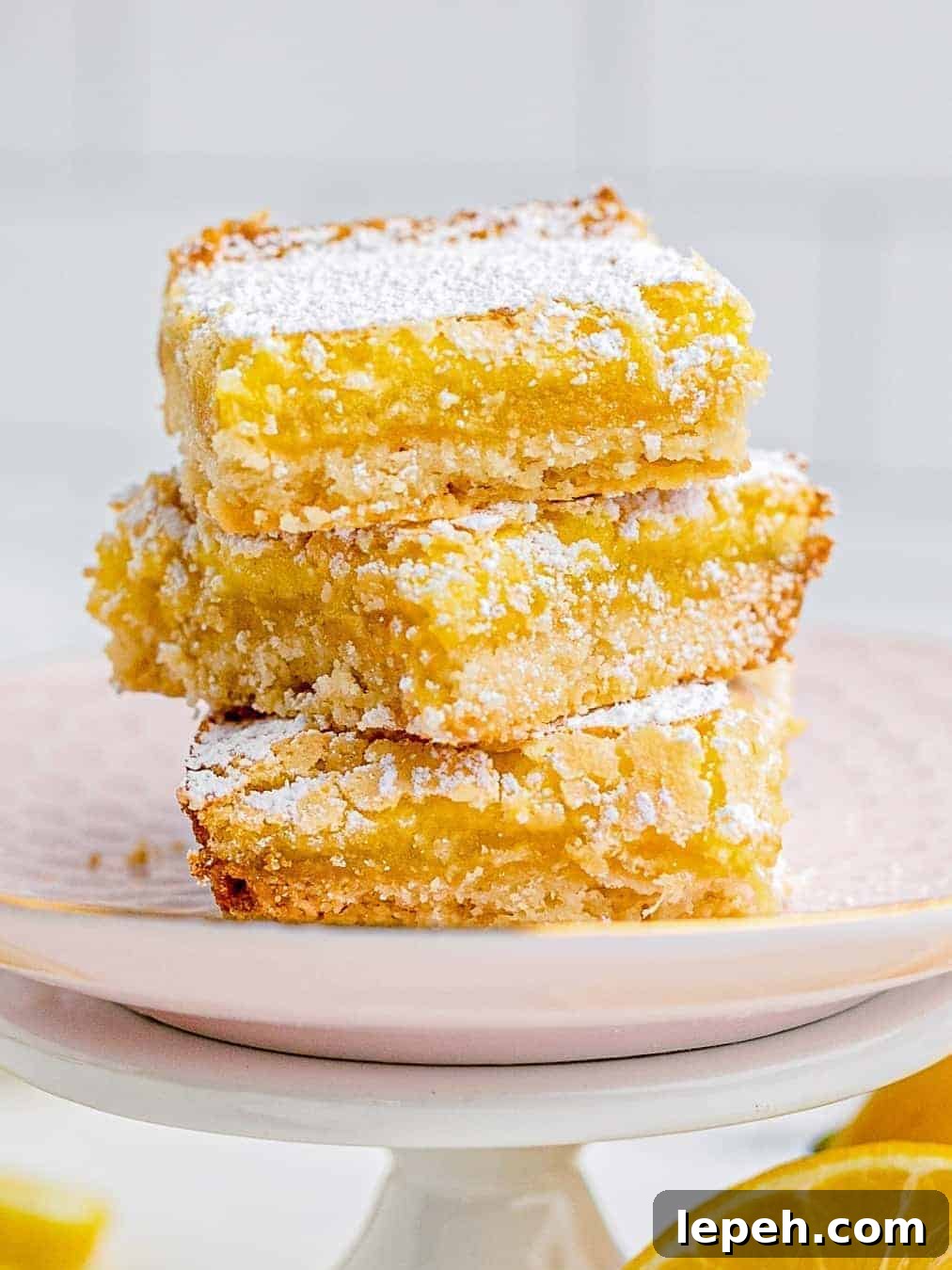 stacked lemon bars on pink plate