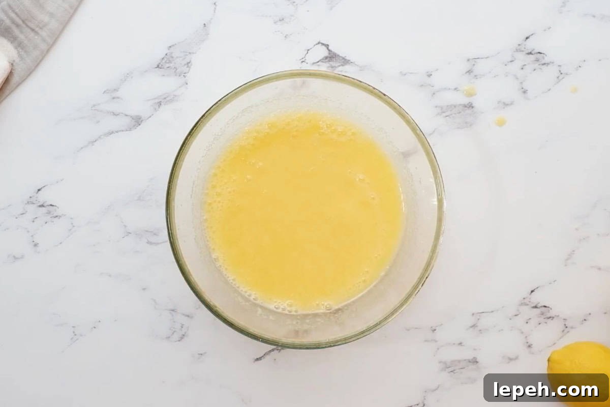 foamy beaten eggs in a glass bowl.