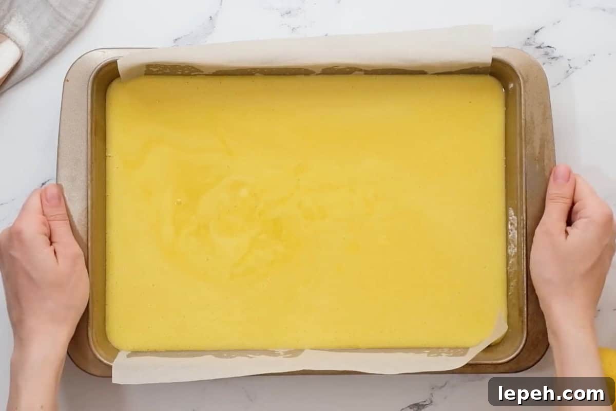 lemon bars in a baking pan before baking.