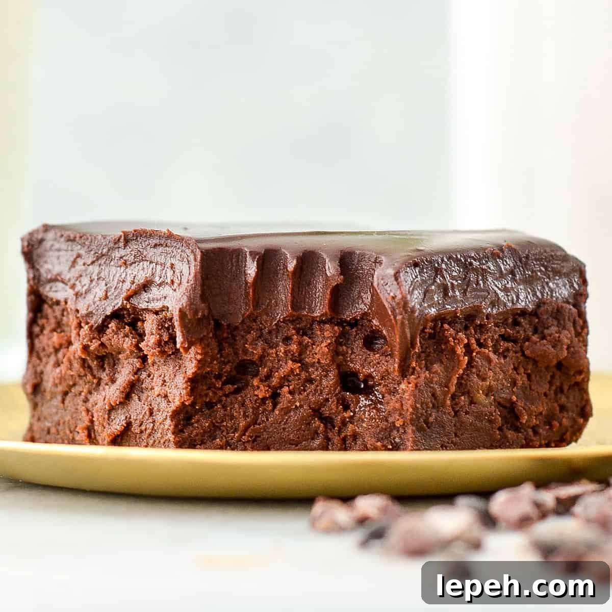 front view of a healthy brownie on a plate with a bite taken out of it