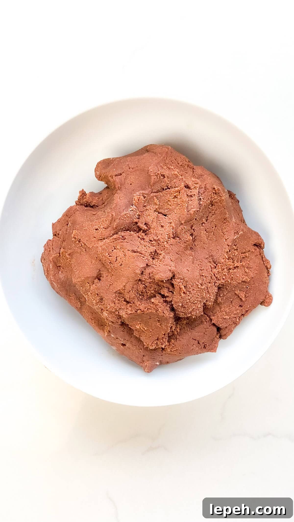 Mixed cookie batter, in a bowl.